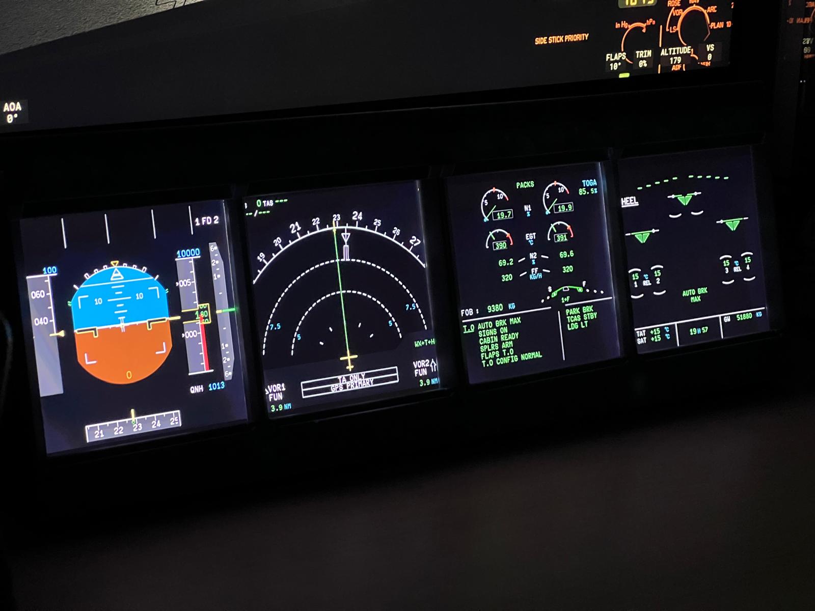 IESims ECAM and EFIS panels illuminated in a dark night flight simulation setting.